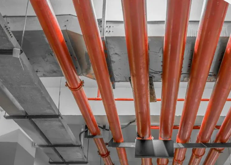 Fire sprinkler pipes below a ceiling. Illustrative image from the developer's catalogue, not the building itself