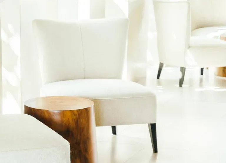 Lounge chairs beside a side table. Illustrative image from the developer's catalogue, not the building itself